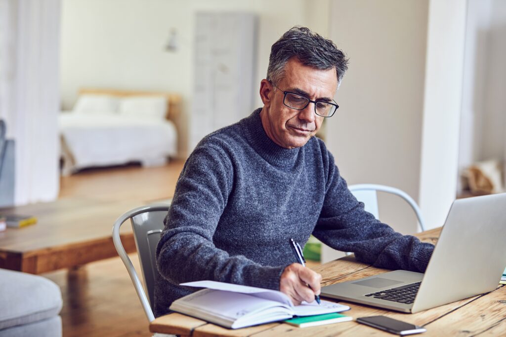 Shot of a senior man using a laptop at home