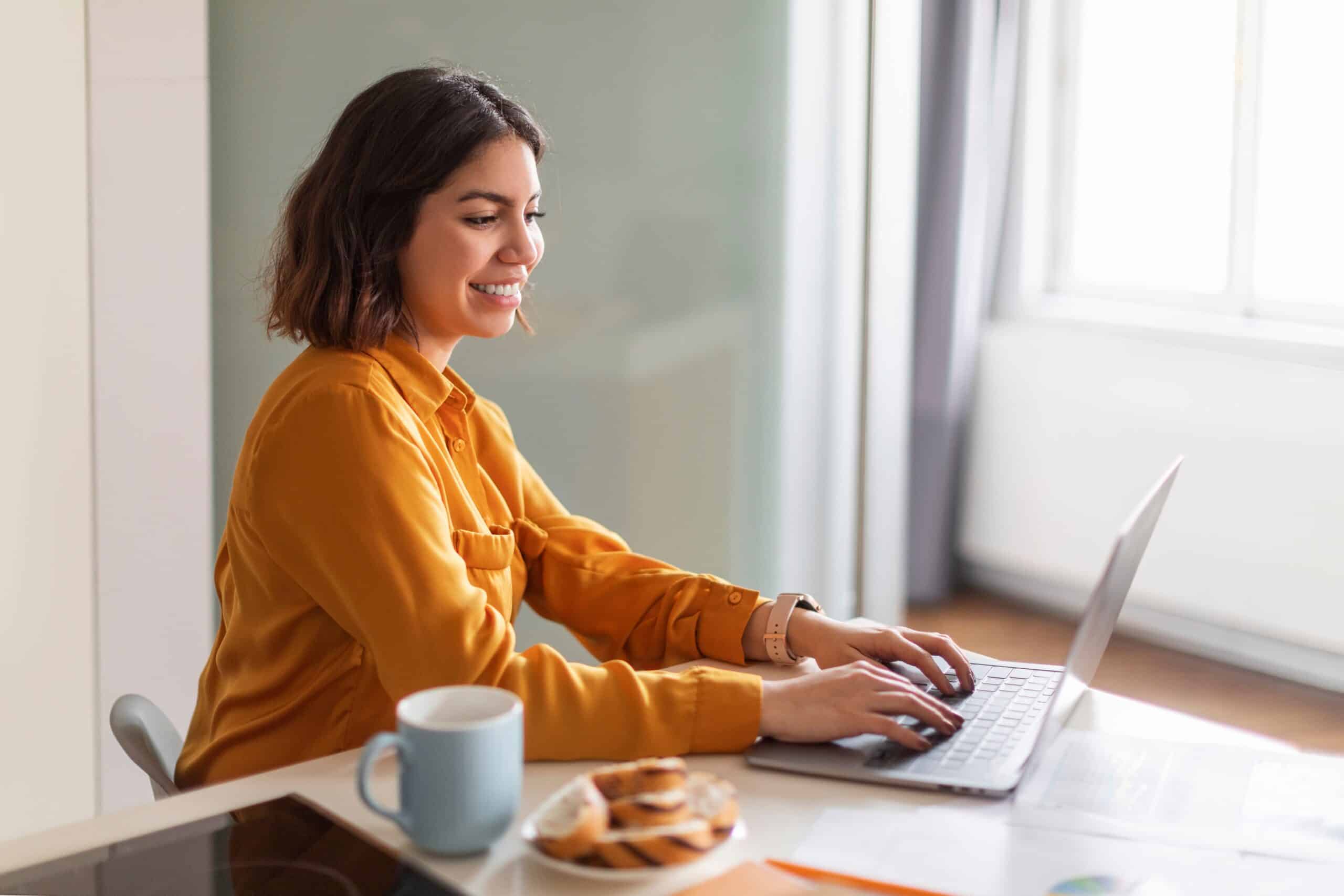 Smiling woman working on her laptop in a relaxing environment