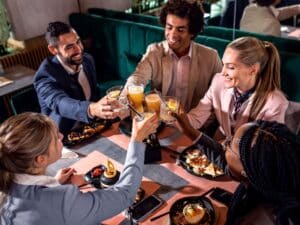A smiling group having dinner and drinks